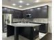 Modern kitchen featuring a large island, stainless steel appliances, and sleek cabinetry at 11464 Center Lake Dr, Windermere, FL 34786