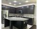 Modern kitchen featuring a large island, stainless steel appliances, and sleek cabinetry at 11464 Center Lake Dr, Windermere, FL 34786