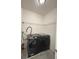 Modern laundry room features side-by-side washer and dryer, complemented by functional wire shelving at 11464 Center Lake Dr, Windermere, FL 34786