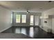 Bright living room with dark floors, lots of natural light, and modern TV console at 11464 Center Lake Dr, Windermere, FL 34786