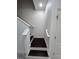 Clean staircase with white railing and dark wood steps, leading to upper level at 11464 Center Lake Dr, Windermere, FL 34786