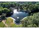 A pristine lake reflects the sunlight, surrounded by vibrant green trees and lush lawns at 115 Tomoka Trl # 115, Longwood, FL 32779