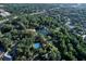 Aerial view showcases community lush green landscapes, pool, walking paths, and tranquil lake at 115 Tomoka Trl # 115, Longwood, FL 32779
