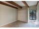 Bright bedroom with tile flooring, beamed ceiling, and natural light from large window at 115 Tomoka Trl # 115, Longwood, FL 32779
