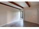 Bedroom showcasing tile floors, beamed ceilings, large window, and double-door closet at 115 Tomoka Trl # 115, Longwood, FL 32779
