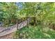 Picturesque wooden bridge surrounded by lush greenery, offering a serene outdoor view at 115 Tomoka Trl # 115, Longwood, FL 32779