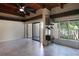 Bright and airy living room with wood beam ceiling, tile floors and large windows overlooking trees at 115 Tomoka Trl # 115, Longwood, FL 32779