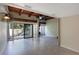 Bright living room featuring tile floors, exposed wood beams, and sliding glass doors to outside at 115 Tomoka Trl # 115, Longwood, FL 32779