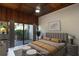 Cozy primary bedroom features a king bed, wood ceiling, and access to a private outdoor space at 115 Tomoka Trl # 115, Longwood, FL 32779