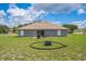 Expansive backyard featuring a patio area for outdoor dining and a fire pit for cozy evenings at 117 Sanderling Dr, Haines City, FL 33844