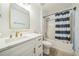 This newly updated bathroom features a tub/shower combo and modern vanity with gold fixtures at 117 Sanderling Dr, Haines City, FL 33844