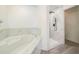 This stunning bathroom features a walk-in shower, soaking tub and tile surround at 117 Sanderling Dr, Haines City, FL 33844