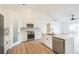 This updated kitchen features white cabinets, stainless steel appliances, and island with sink at 117 Sanderling Dr, Haines City, FL 33844