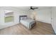 Spacious main bedroom boasts a ceiling fan, natural light, and an ensuite bathroom for convenience at 117 Sanderling Dr, Haines City, FL 33844
