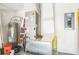 This utility room has a water heater, HVAC unit and breaker box ready to keep the home running efficiently at 117 Sanderling Dr, Haines City, FL 33844