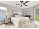 Bright bedroom with a ceiling fan, modern decor, and sliding glass doors to the backyard at 1195 Tivoli Dr, Deltona, FL 32725