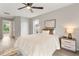 Bright bedroom featuring a ceiling fan, natural light, and neutral decor throughout at 1195 Tivoli Dr, Deltona, FL 32725