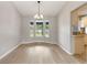 Bright dining room with a large window and light wood flooring throughout at 1195 Tivoli Dr, Deltona, FL 32725