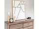 Stylish dresser featuring geometric artwork, modern lamps, and dark hardware at 1195 Tivoli Dr, Deltona, FL 32725