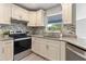 Modern kitchen boasting granite countertops, stainless steel appliances, and tiled backsplash at 1195 Tivoli Dr, Deltona, FL 32725