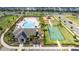 Aerial view of a community recreation area with a swimming pool, playground, and tennis court at 12133 Bracco St, Winter Garden, FL 34787
