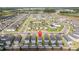 Wide aerial view showing a community with rows of homes, a community pool and lake at 12133 Bracco St, Winter Garden, FL 34787