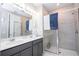 Well-lit bathroom featuring a glass-enclosed shower, double vanity, and modern fixtures at 12133 Bracco St, Winter Garden, FL 34787
