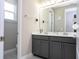 Well-lit bathroom featuring a double vanity, gray cabinets, and modern fixtures at 12133 Bracco St, Winter Garden, FL 34787