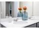 Close up of a bathroom vanity with double sinks, decorative soap and flower vases at 12133 Bracco St, Winter Garden, FL 34787