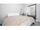 Bedroom boasts a large mirror and comfortable bed with white throw pillows in a neutral, well-lit space at 12133 Bracco St, Winter Garden, FL 34787