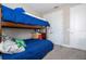 Bedroom showcasing a bunk bed with a comfortable blue comforter and carpeted floors at 12133 Bracco St, Winter Garden, FL 34787