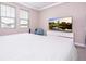 Bright bedroom featuring plush carpet, neutral walls, and a large television at 12133 Bracco St, Winter Garden, FL 34787