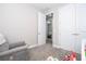 Bedroom featuring plush carpeting, a gray rocking chair and access to additional storage space and an additional room at 12133 Bracco St, Winter Garden, FL 34787