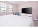Bright bedroom featuring plush carpet, neutral walls, and a large television at 12133 Bracco St, Winter Garden, FL 34787