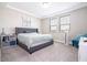 Bright bedroom with plush carpeting, tray ceiling, large windows, and a cozy sitting area at 12133 Bracco St, Winter Garden, FL 34787