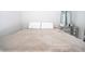 Neutral bedroom featuring a comfortable bed with throw pillows and a mirrored nightstand with modern decor at 12133 Bracco St, Winter Garden, FL 34787