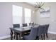 Elegant dining area with modern chandelier, stylish decor, and plenty of natural light at 12133 Bracco St, Winter Garden, FL 34787