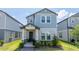 Charming two-story home with a covered front porch and lush landscaping at 12133 Bracco St, Winter Garden, FL 34787