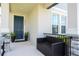 Inviting front porch featuring a dark blue front door, potted plants, and comfortable seating at 12133 Bracco St, Winter Garden, FL 34787