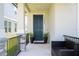 Inviting front porch featuring a dark blue front door, potted plants, and comfortable seating at 12133 Bracco St, Winter Garden, FL 34787