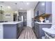 Modern kitchen featuring stainless steel appliances, gray cabinetry, and quartz countertops at 12133 Bracco St, Winter Garden, FL 34787