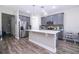 Modern kitchen with stainless steel appliances, gray cabinets, and a large center island with a sink at 12133 Bracco St, Winter Garden, FL 34787