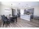 Open-concept kitchen featuring gray cabinetry, stainless steel appliances, and a large island at 12133 Bracco St, Winter Garden, FL 34787