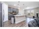 Modern kitchen with grey cabinets, stainless steel appliances, and a large island at 12133 Bracco St, Winter Garden, FL 34787