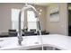 Stylish chrome kitchen faucet with quartz countertop and dining area in background at 12133 Bracco St, Winter Garden, FL 34787