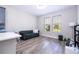 Cozy living room with wood floors, a comfortable sofa, and a large window with natural light at 12133 Bracco St, Winter Garden, FL 34787
