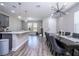 Open-concept living room with modern lighting fixtures and view of kitchen with island at 12133 Bracco St, Winter Garden, FL 34787