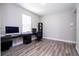 Home office features wood floors, natural light, and black shelving for storage at 12133 Bracco St, Winter Garden, FL 34787