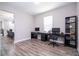 Home office features wood floors, natural light, and black shelving for storage at 12133 Bracco St, Winter Garden, FL 34787