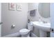 Stylish powder room with pedestal sink and decorative wall art at 12133 Bracco St, Winter Garden, FL 34787